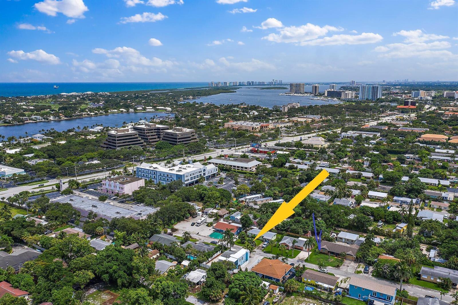 An aerial view shows a residential neighborhood with a yellow arrow pointing to a house — 1779 Len Drive # 1, North Palm Beach FL 33408, NORTH PALM BEACH, FL