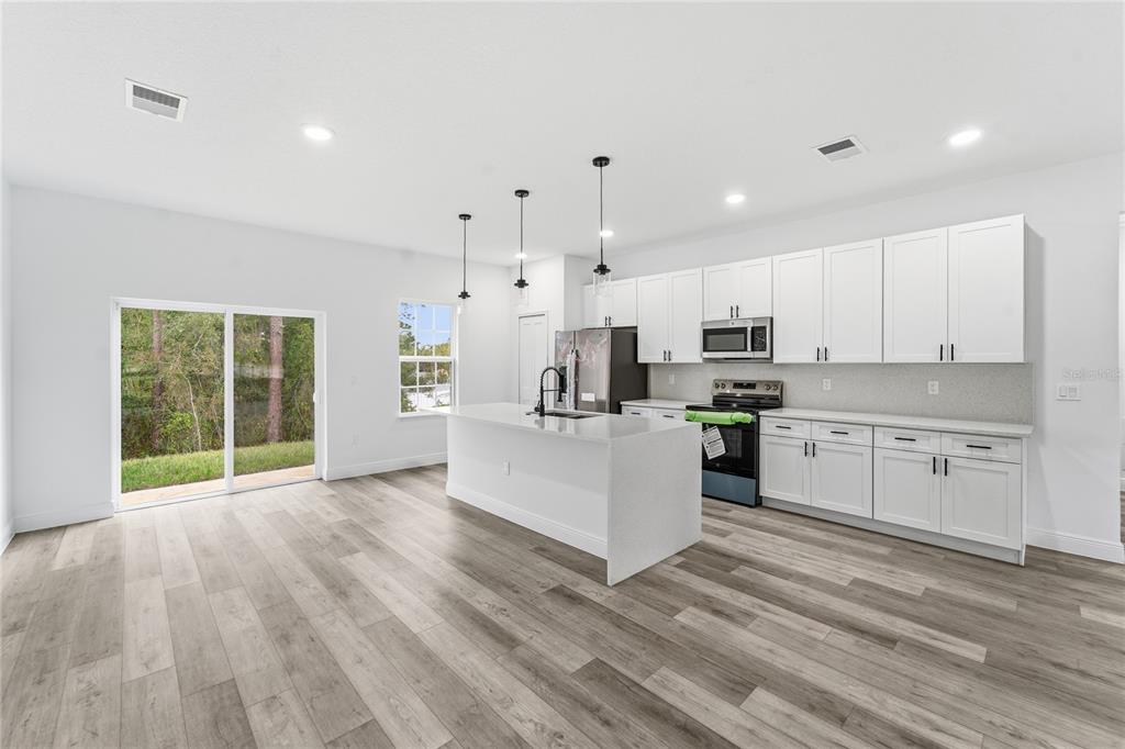 An aerial view of a single-story house with a paved driveway and white vinyl fencing — 2773 SW 147ST STREET RD, OCALA, FL