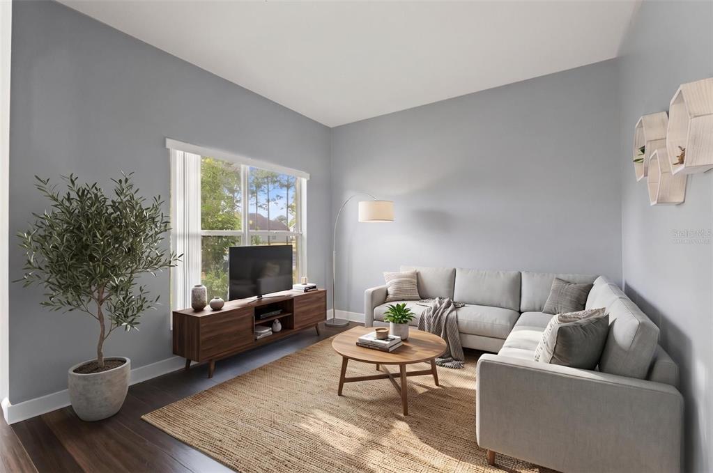 A living room features a sectional sofa, a wooden coffee table, and a media console — 5683 BRACKENWOOD DRIVE, SPRING HILL, FL