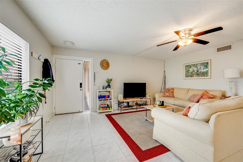 The exterior of a multi-story stucco building features a front entrance and a concrete walkway — 200 INTERNATIONAL DRIVE UNIT 505, CAPE CANAVERAL, FL
