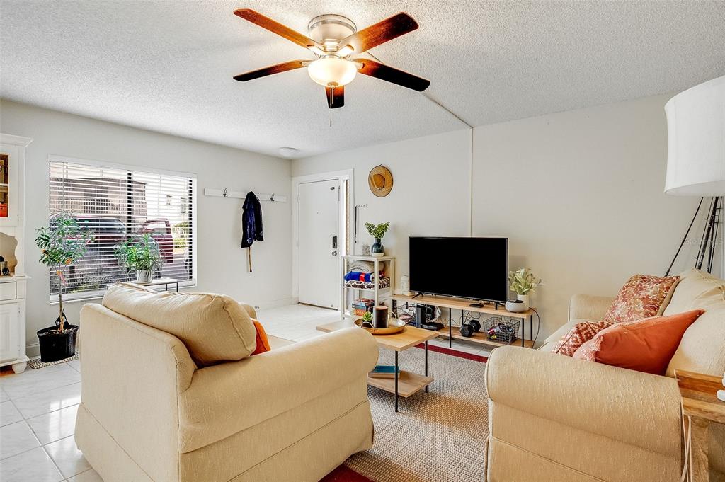 An entryway features light green walls, white tile flooring, a shoe rack, and a storage shelf — 200 INTERNATIONAL DRIVE UNIT 505, CAPE CANAVERAL, FL