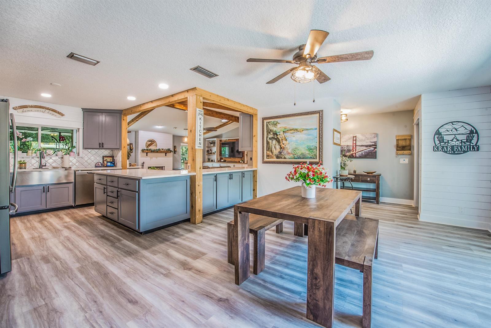 A kitchen and dining area with gray cabinets, a wooden island, and a wooden table — 12970 179th Ct N, Jupiter FL 33478, JUPITER, FL