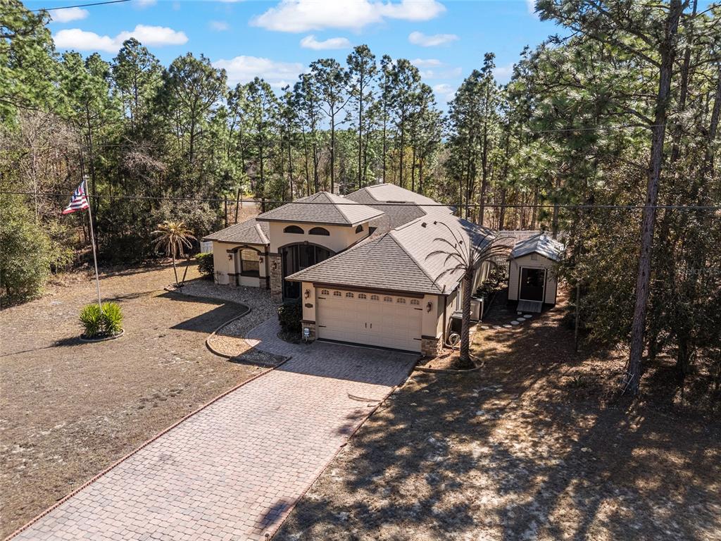 An aerial view shows a single-story house with a paved driveway and a detached shed — 1198 W CITRUS SPRINGS BOULEVARD, CITRUS SPRINGS, FL