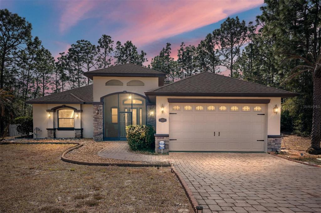 A single-story house with a stone-accented facade, a two-car garage, and a paved walkway — 1198 W CITRUS SPRINGS BOULEVARD, CITRUS SPRINGS, FL