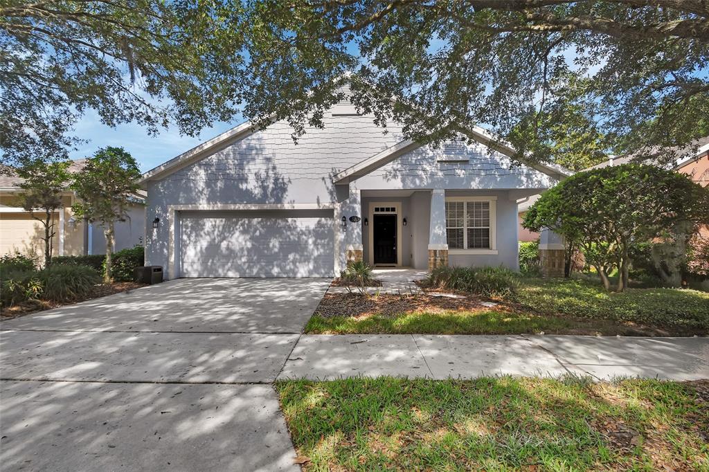 A single-story house with a gray exterior, a two-car garage, and a covered front porch — 525 HERON POINT WAY, DELAND, FL