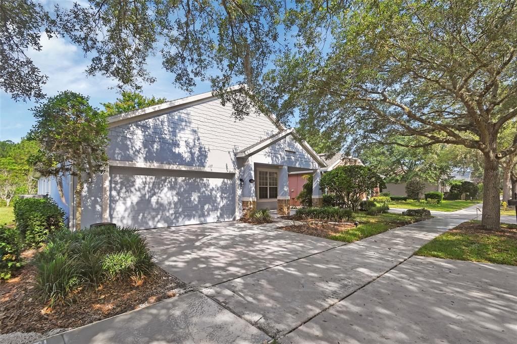 A light blue single-story house with a two-car garage and a concrete driveway — 525 HERON POINT WAY, DELAND, FL