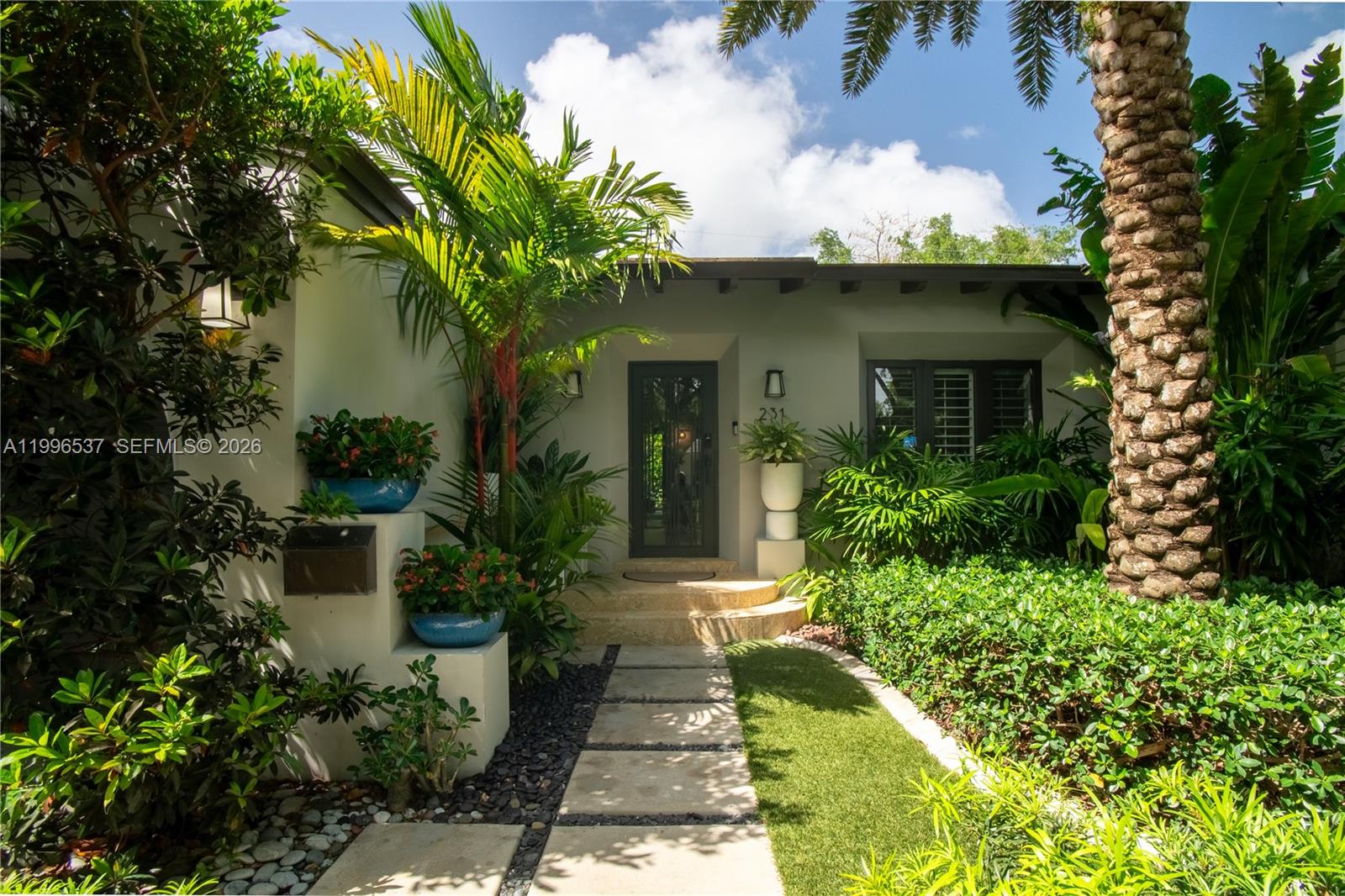 A front entrance features a paved walkway, lush tropical landscaping, and a glass-paneled door — 231 Fluvia Ave # 0, Coral Gables FL 33134, CORAL GABLES, FL