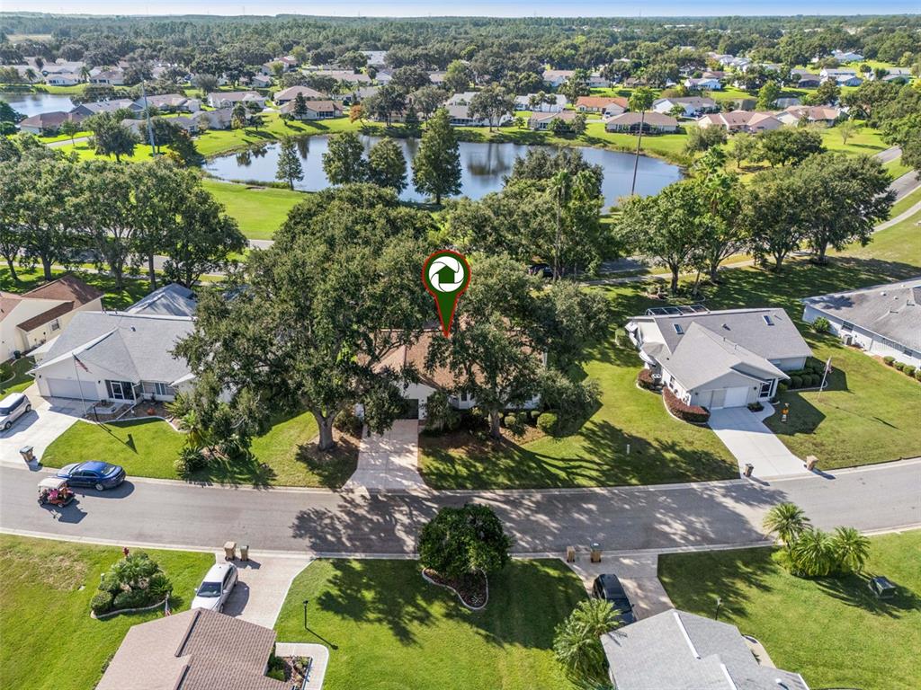 An aerial view shows a suburban house with a large tree in the front yard — 5616 LAVER STREET, LEESBURG, FL