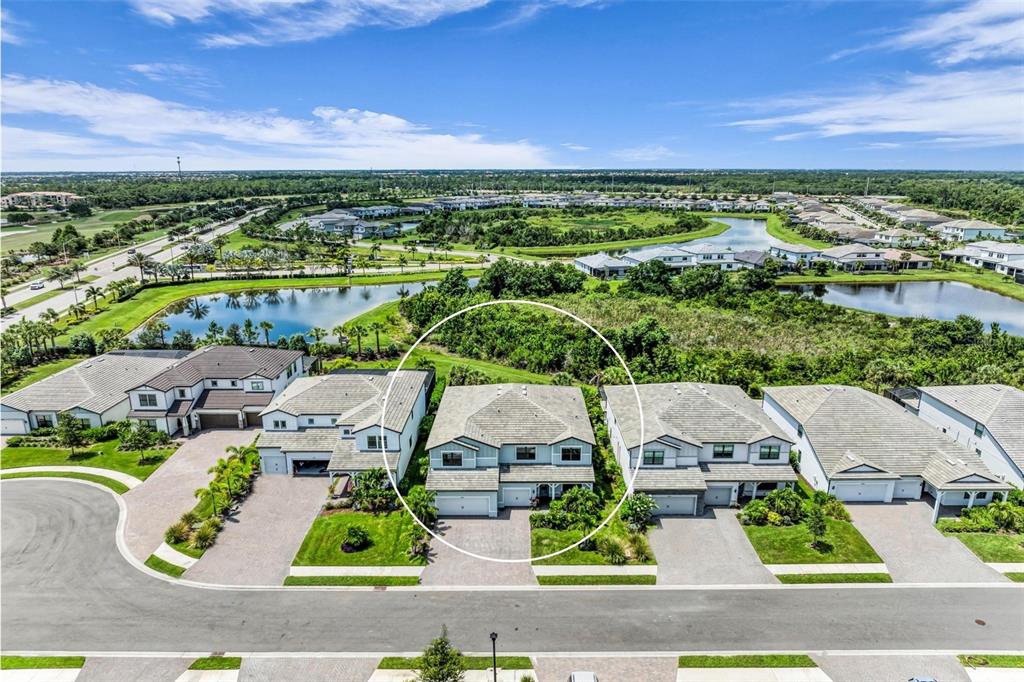 An aerial view shows a two-story suburban house circled in a residential neighborhood — 16438 SLATE PLACE, LAKEWOOD RANCH, FL