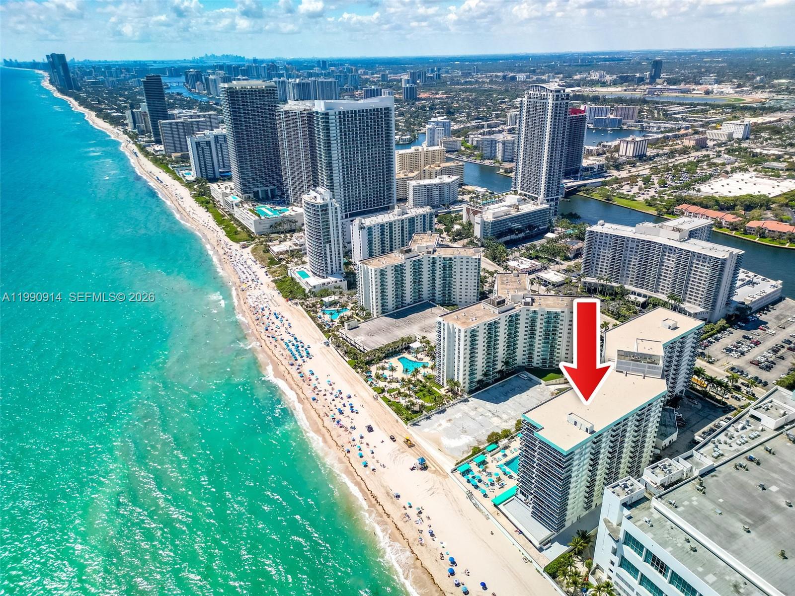An aerial view shows a high-rise beachfront condominium building marked by a red arrow — 3725 S Ocean Dr, Hollywood FL 33019, HOLLYWOOD, FL