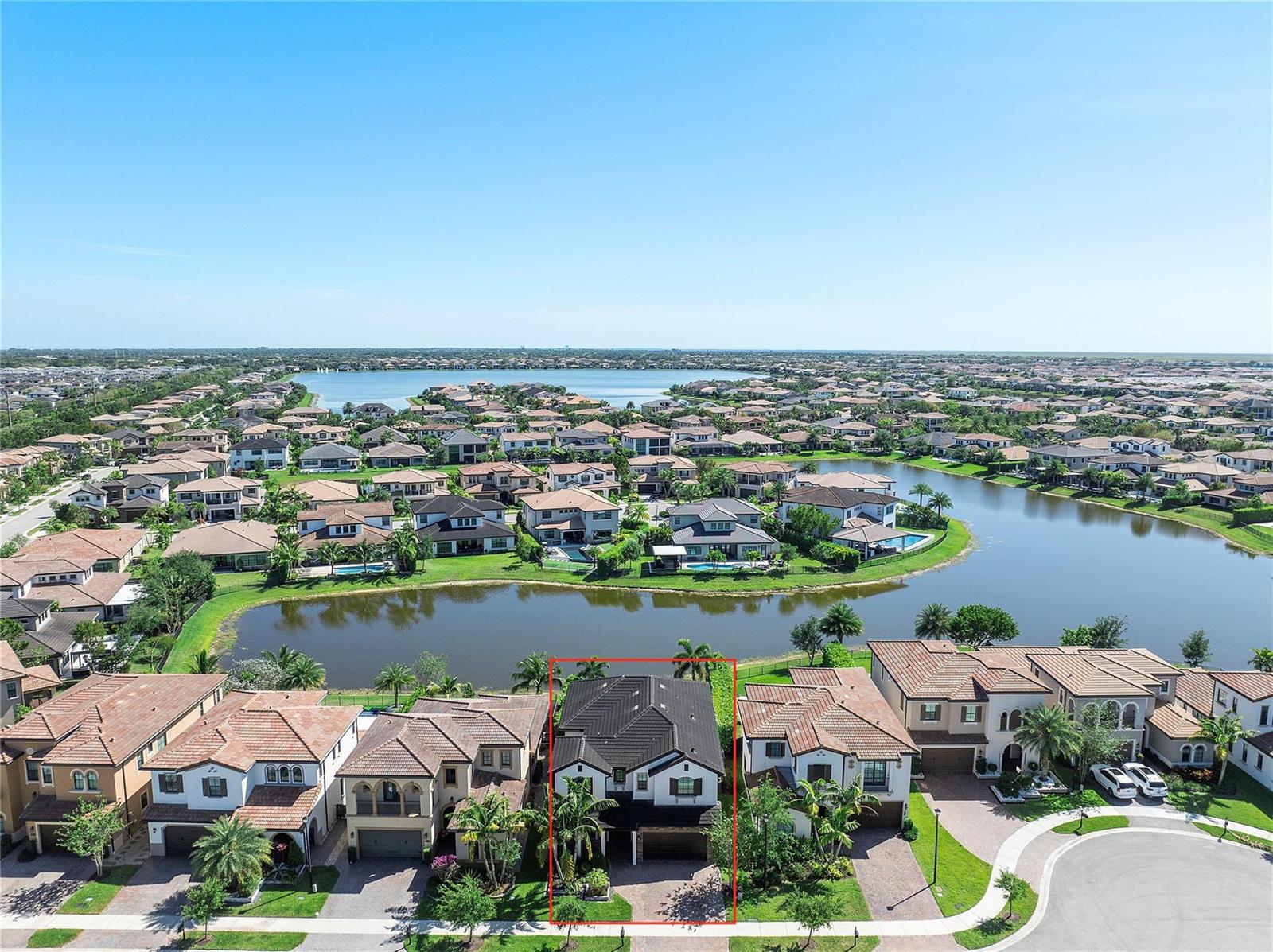 An aerial view shows a two-story house with a dark roof highlighted by a red border — 11036 Meridian Drive N, Parkland FL 33076, PARKLAND, FL