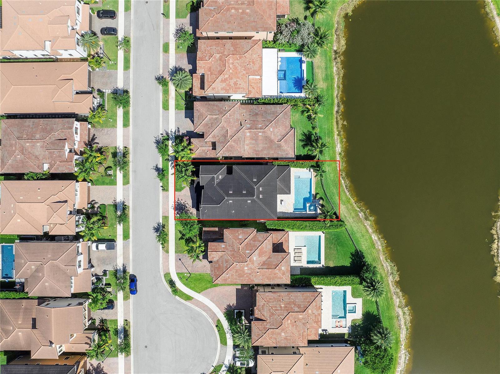 An aerial view shows a residential house with a dark roof and a swimming pool — 11036 Meridian Drive N, Parkland FL 33076, PARKLAND, FL