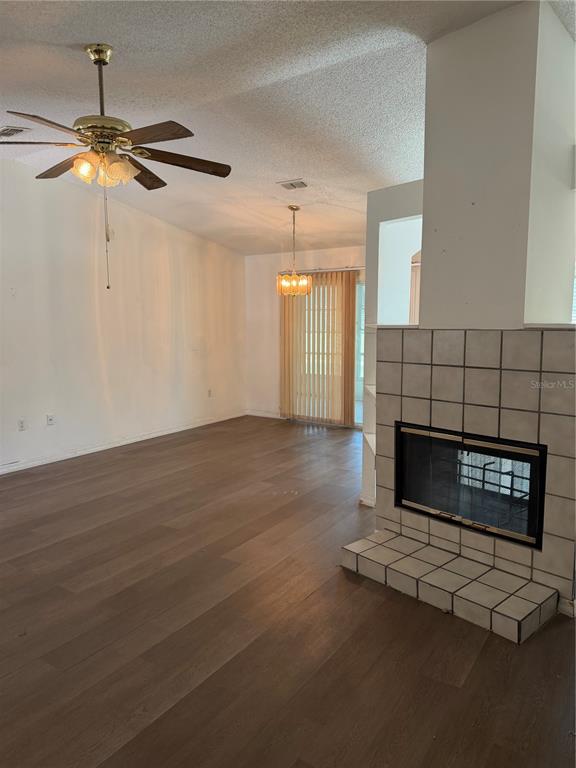 A living room features wood-look flooring, a ceiling fan, a fireplace, and a dining area — 412 WESTWOOD DRIVE, LEESBURG, FL