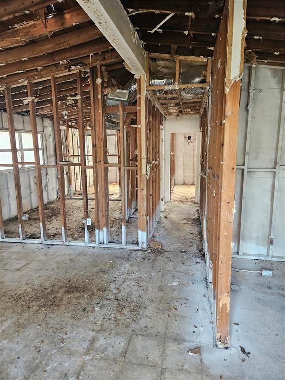 An interior view of a room under construction with exposed wooden wall studs and ceiling joists — 2814 PALMADELIA AVENUE, SARASOTA, FL