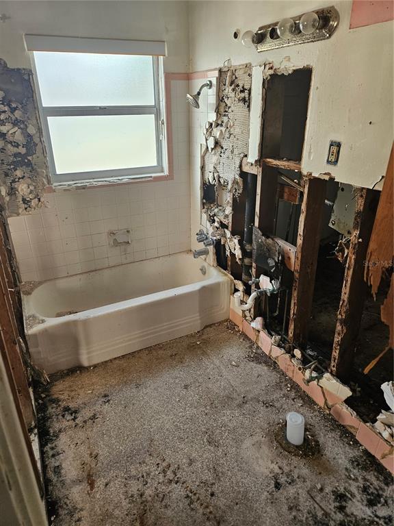 A bathroom under renovation with exposed wall studs, a bathtub, and a missing vanity — 2814 PALMADELIA AVENUE, SARASOTA, FL
