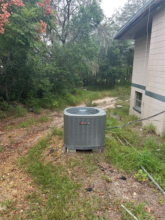 An outdoor Trane air conditioning unit sits on the ground beside a house exterior — 4998 LAKE LOWERY ROAD, HAINES CITY, FL