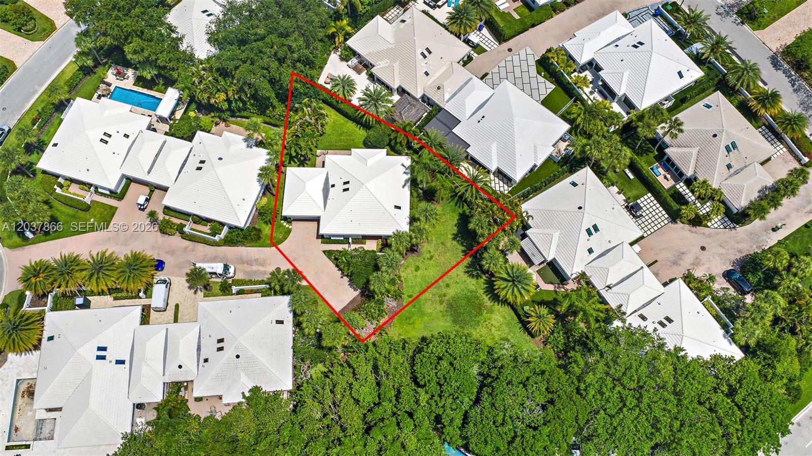 An aerial view shows a residential house with a white roof and a large yard — 4501 Captains Way, Jupiter FL 33477, JUPITER, FL