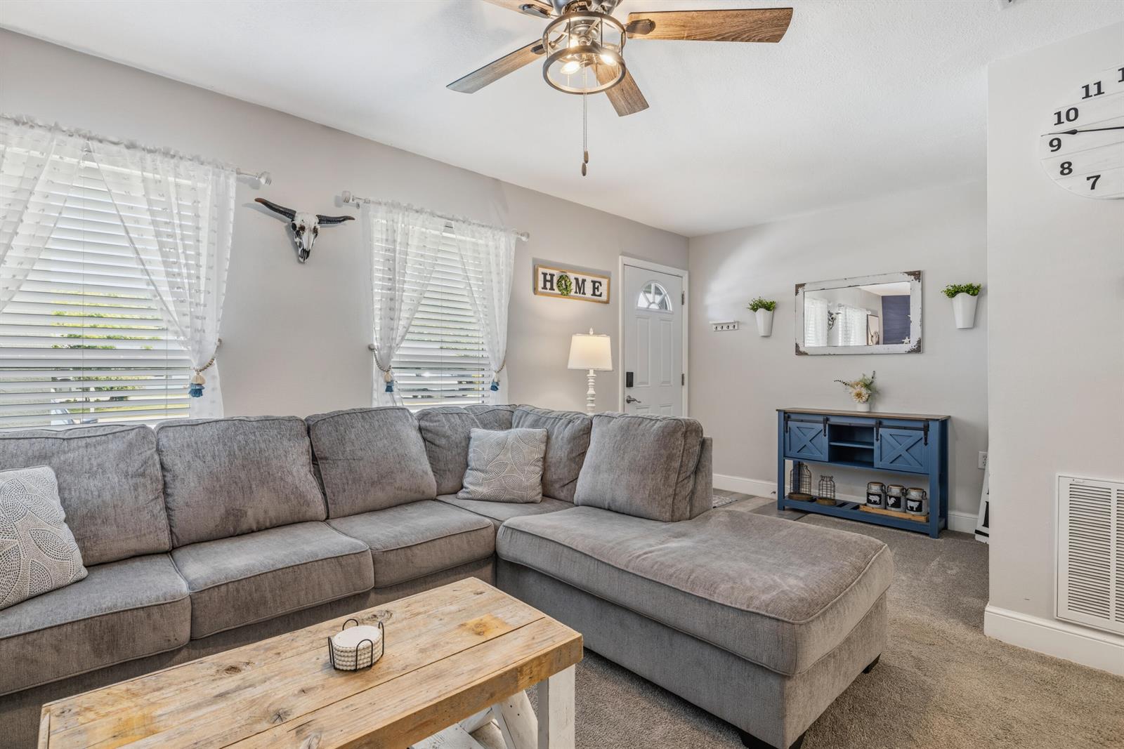 A living room features a gray sectional sofa, a wooden coffee table, and a blue console — 305 17th Avenue, Vero Beach FL 32962, VERO BEACH, FL