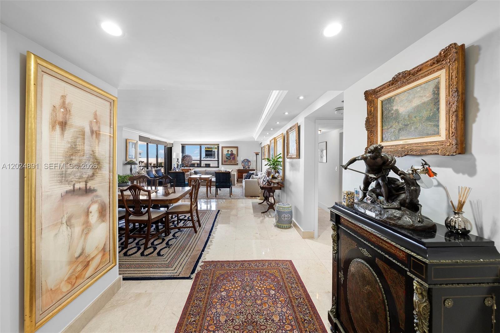 A spacious, open-concept living and dining area features marble floors, ornate artwork, and traditional furniture — 10175 Collins Ave # 1505, Bal Harbour FL 33154, BAL HARBOUR, FL