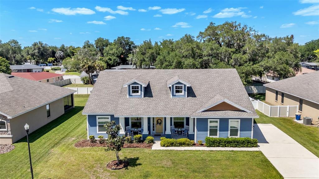 An aerial view shows a blue two-story house with a shingled roof and front porch — 254 KISSENGEN PARK DRIVE, BARTOW, FL