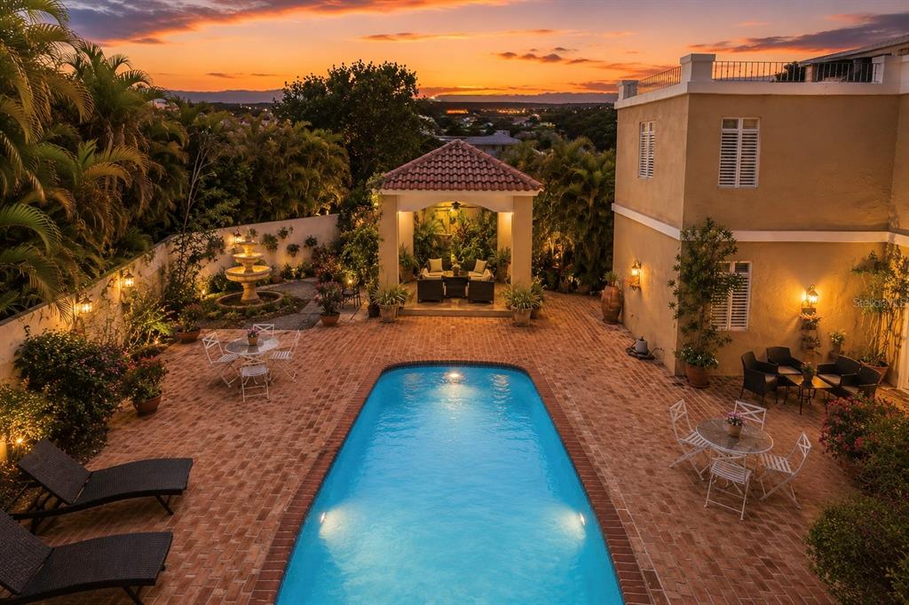 An aerial view of a backyard featuring a swimming pool, brick patio, and covered gazebo — Carr 100 km 2.7 BO. GUANAJIBO, CABO ROJO, PR