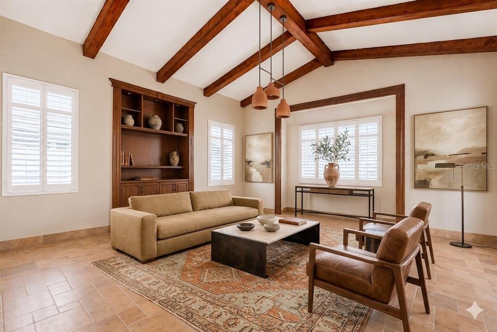 A living room features a vaulted ceiling with wood beams, tile floors, and a sofa — Carr 100 km 2.7 BO. GUANAJIBO, CABO ROJO, PR
