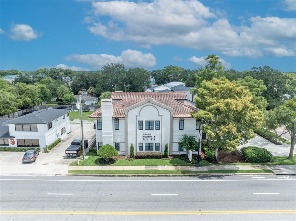 An aerial view of a two-story commercial building with a tiled roof and parking lot — 1477 W FAIRBANKS AVENUE, WINTER PARK, FL