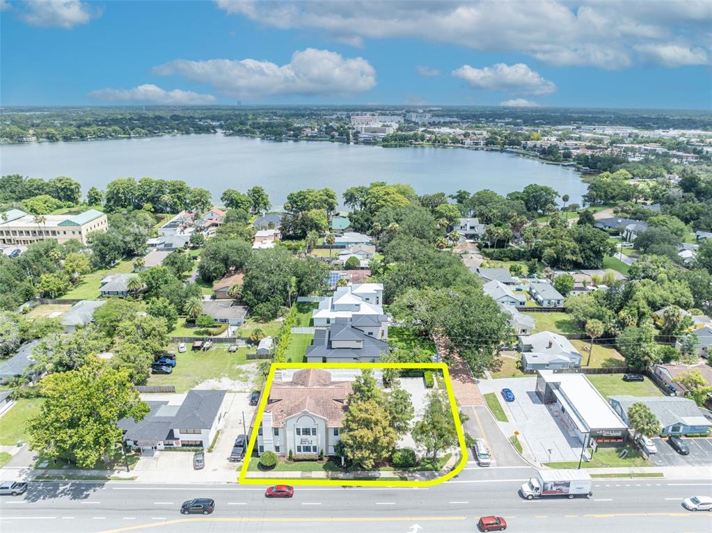 An aerial view shows a two-story building with a tiled roof highlighted by a yellow border — 1477 W FAIRBANKS AVENUE, WINTER PARK, FL