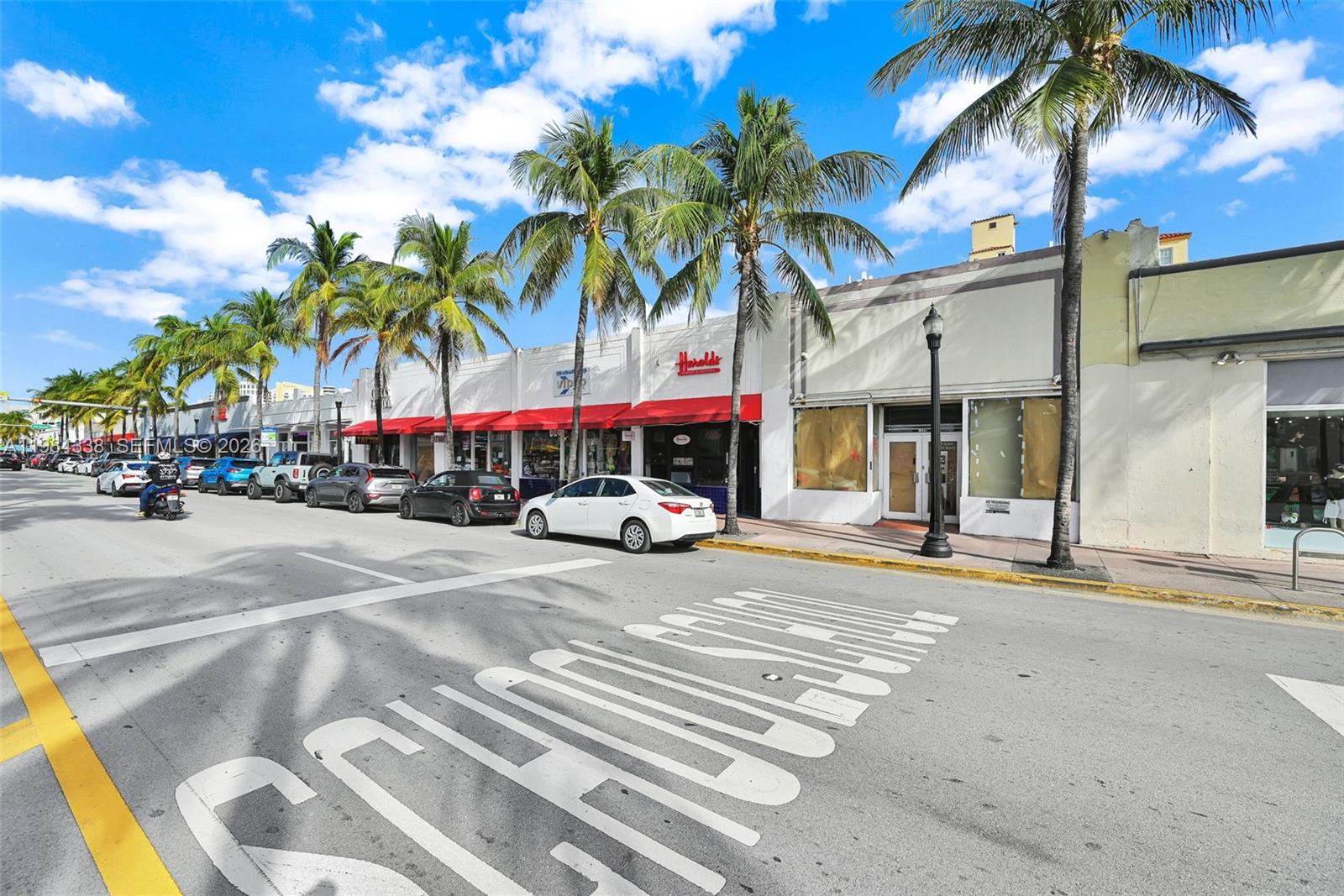 A street view shows a row of storefronts with palm trees and parked cars — 1323 Washington Ave, Miami Beach FL 33139, MIAMI BEACH, FL