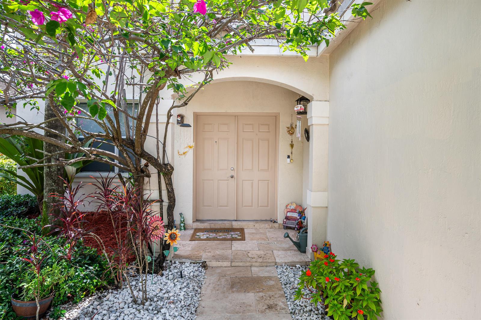 A beige double front door with a stone walkway and surrounding landscaping — 229 E Bayridge Drive, Weston FL 33326, WESTON, FL