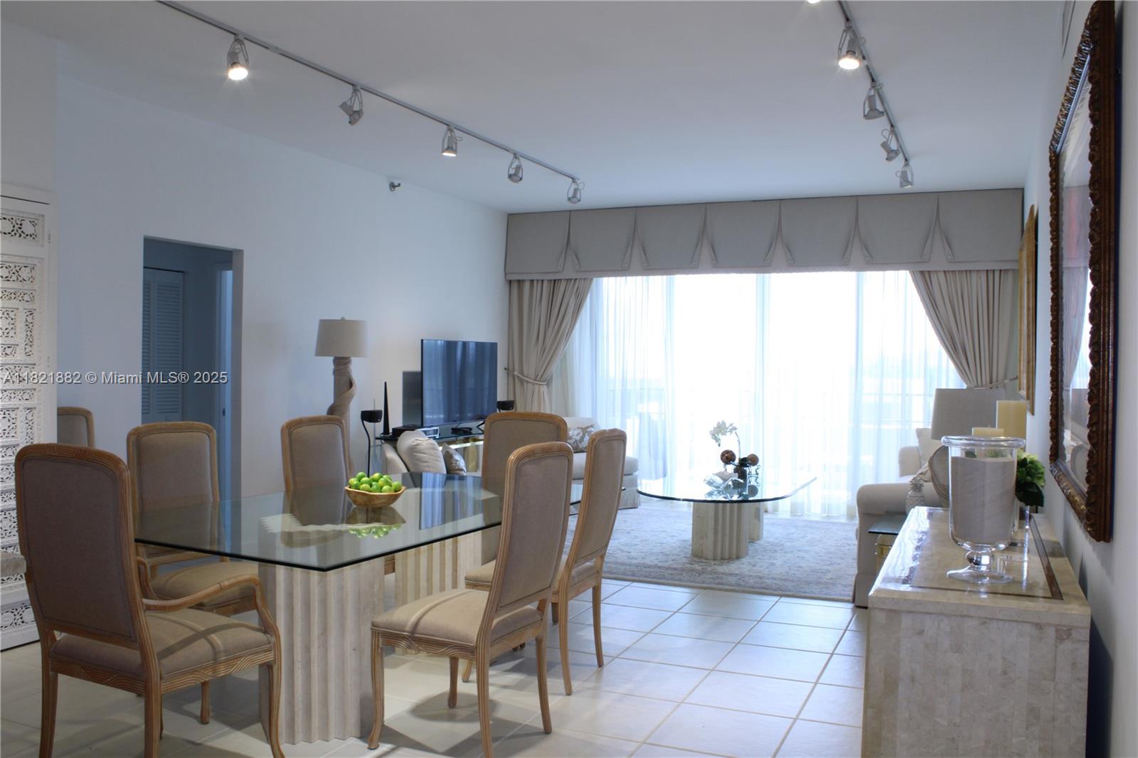 A dining area with a glass table and chairs opens into a living room — 201 Crandon Blvd # 439, Key Biscayne FL 33149, KEY BISCAYNE, FL