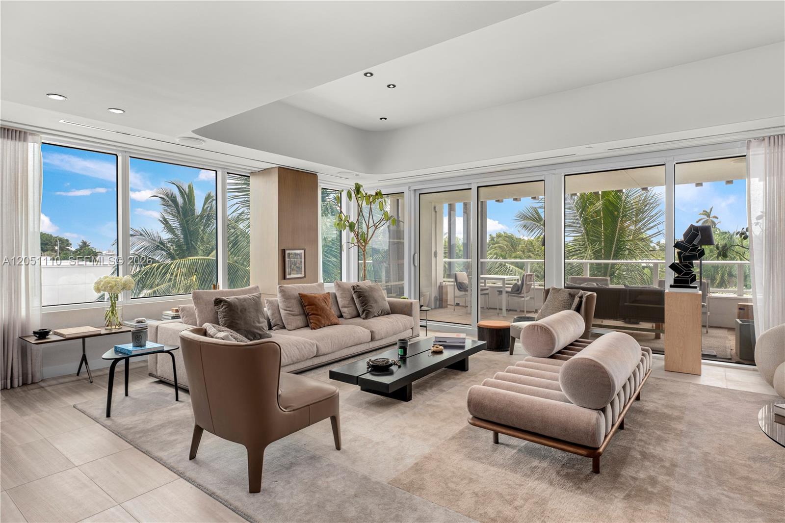 A modern living room features a large sectional sofa, a unique daybed, and floor-to-ceiling windows — 4701 N Meridian Ave # 421, Miami Beach FL 33140, MIAMI BEACH, FL