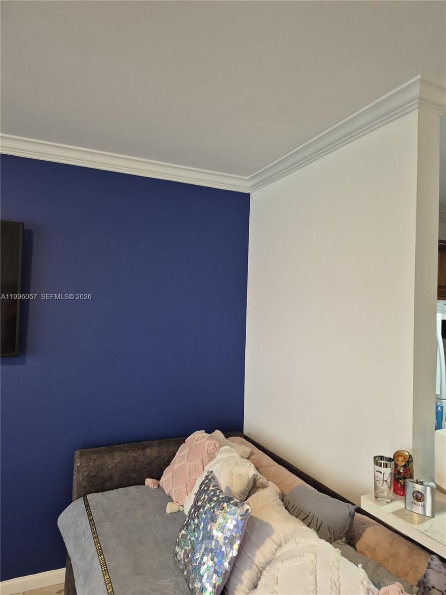 A room features a blue accent wall, a white wall, and a sofa with pillows — 371 brighton I # 371, Boca Raton FL 33434, BOCA RATON, FL