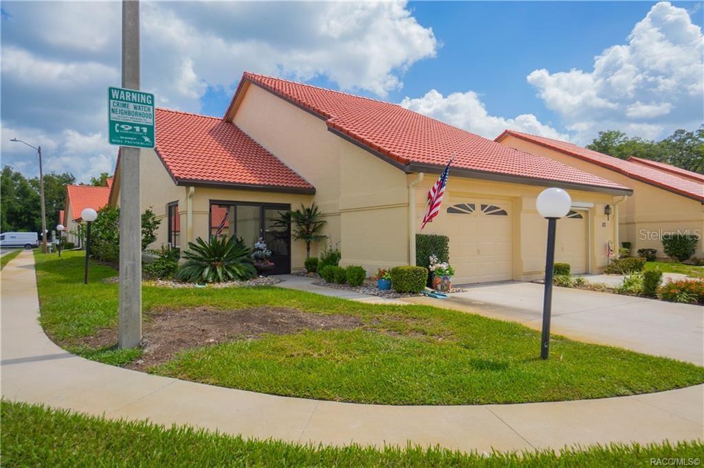 A single-story house with a red tile roof, a garage, and a front lawn — 2022 FOREST DRIVE, INVERNESS, FL