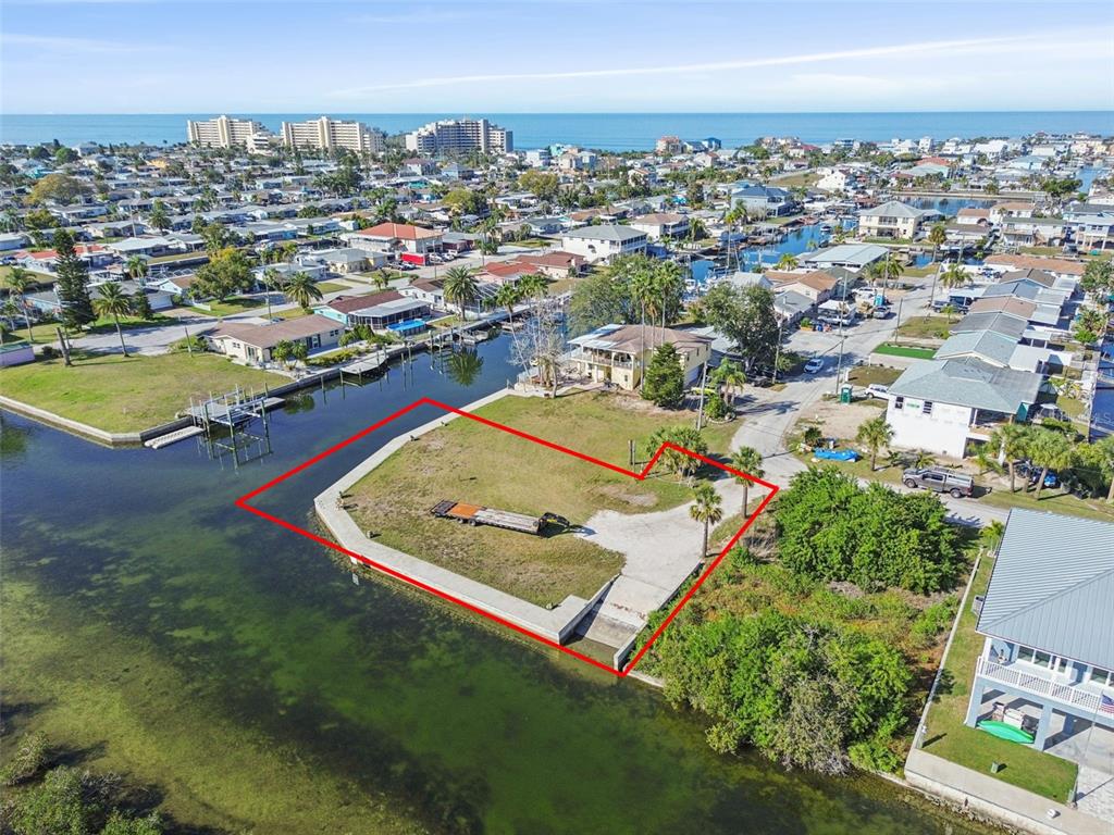 An aerial view shows a vacant waterfront lot outlined in red with a boat ramp — 6374 BOATYARD DRIVE, HUDSON, FL