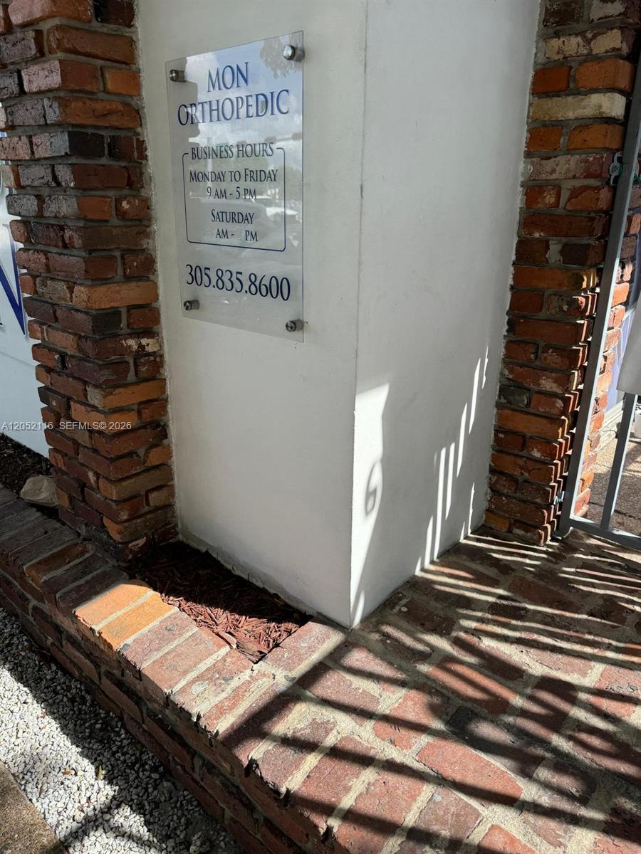 A sign for Mon Orthopedic is mounted on a white pillar between brick columns — 600 E 25th St, Hialeah FL 33013, HIALEAH, FL