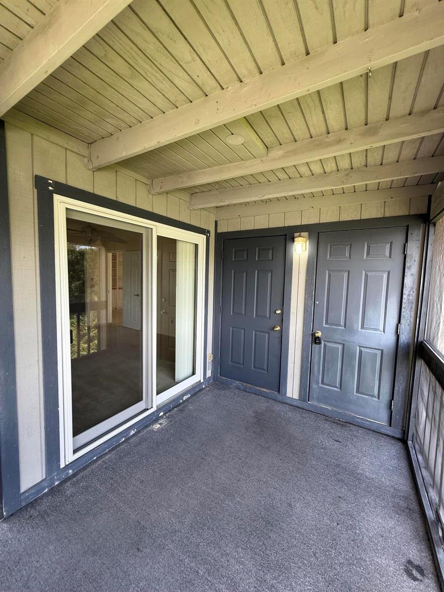 A covered patio features a sliding glass door and two dark gray exterior doors — 8228 SE Croft Circle # 8, Hobe Sound FL 33455, HOBE SOUND, FL