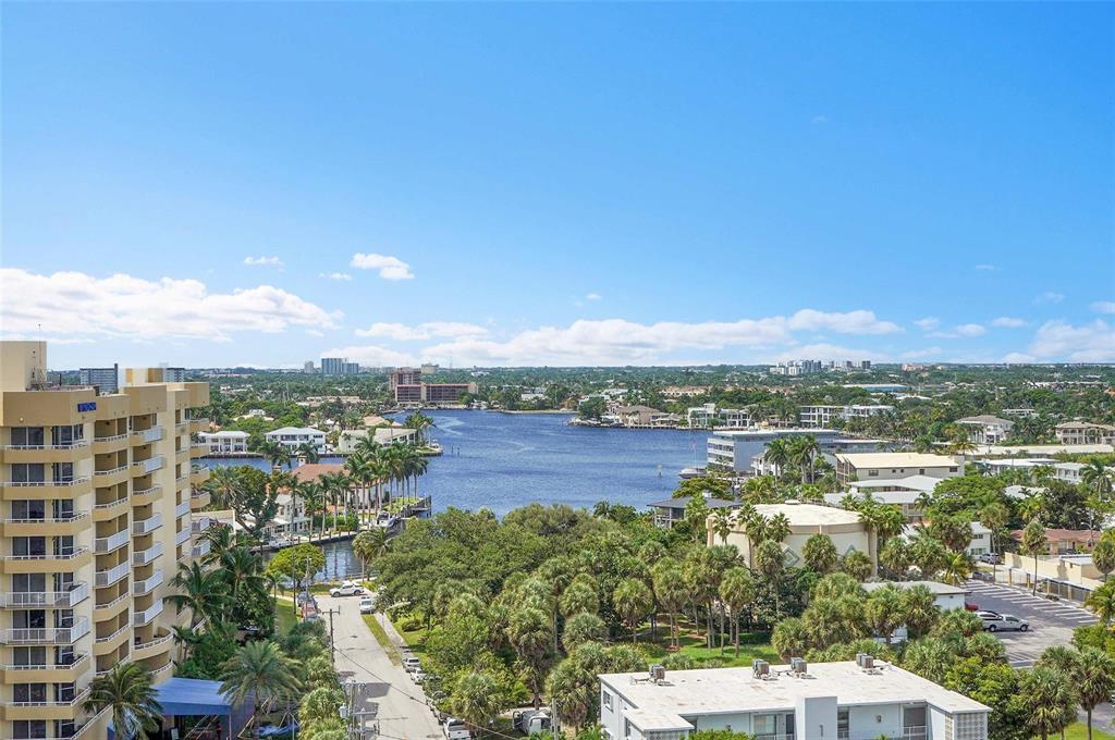 An elevated view of a coastal waterway surrounded by palm trees and residential buildings — 1300 S Ocean Boulevard # 705, Pompano Beach FL 33062, POMPANO BEACH, FL