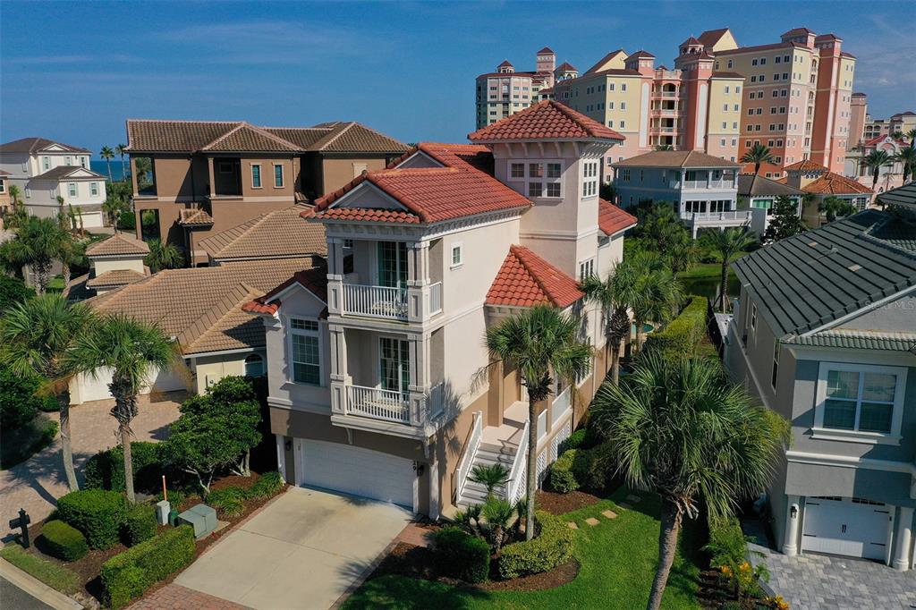 An aerial view shows a three-story house with a red tile roof and balconies — 29 NORTHSHORE AVENUE, PALM COAST, FL