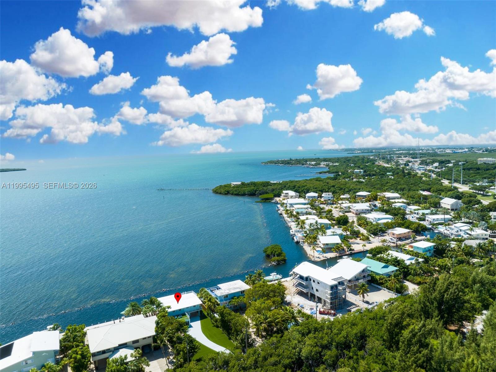 An aerial view shows a coastal neighborhood with a red pin marking a waterfront house — 188 Orange Blossom Rd, Tavernier FL 33070, TAVERNIER, FL