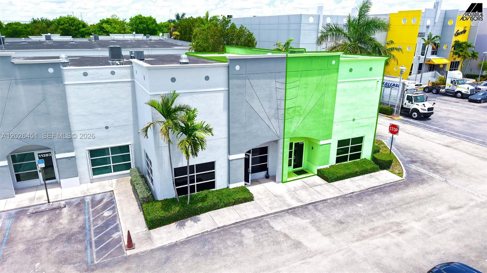 An aerial view shows a commercial building with gray and green exterior walls and landscaping — 11379 NW 122nd St # 11, Medley FL 33178, MEDLEY, FL