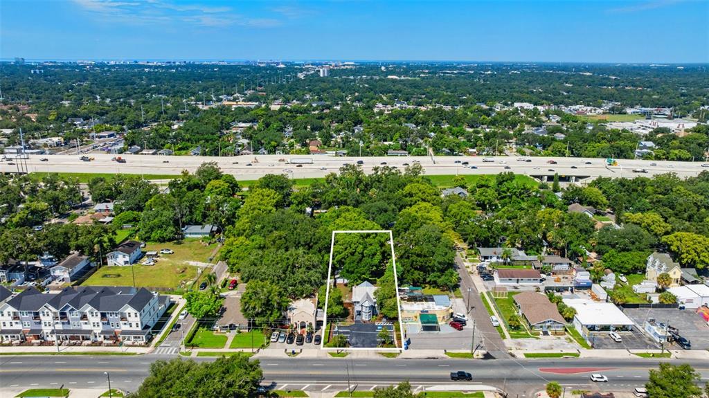 An aerial view shows a house outlined in white, surrounded by trees, near a highway — 4206 NEBRASKA AVENUE N, TAMPA, FL