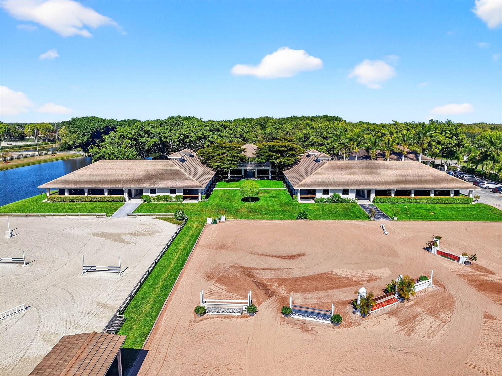 An aerial view shows a U-shaped equestrian facility with two riding arenas and a pond — 3405 Olde Hampton Drive, Wellington FL 33414, WELLINGTON, FL