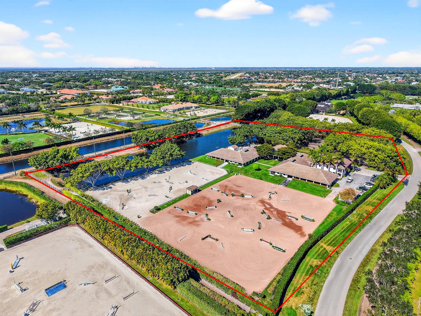 An aerial view shows an equestrian property with two riding arenas and residential buildings — 3405 Olde Hampton Drive, Wellington FL 33414, WELLINGTON, FL