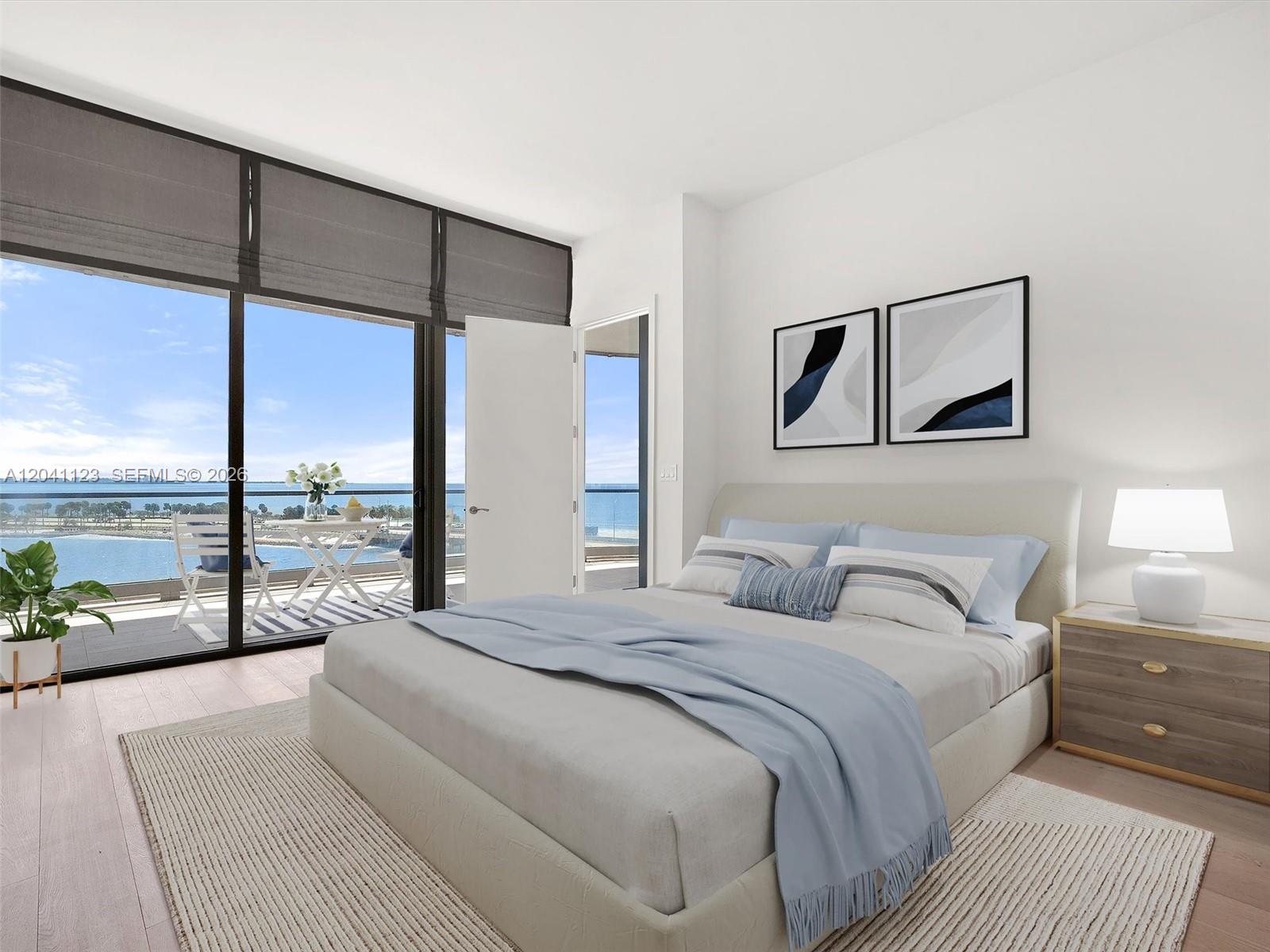 A bedroom features a bed, a nightstand, and a balcony overlooking the ocean — 175 SE 25th Rd # 502, Miami FL 33129, MIAMI, FL