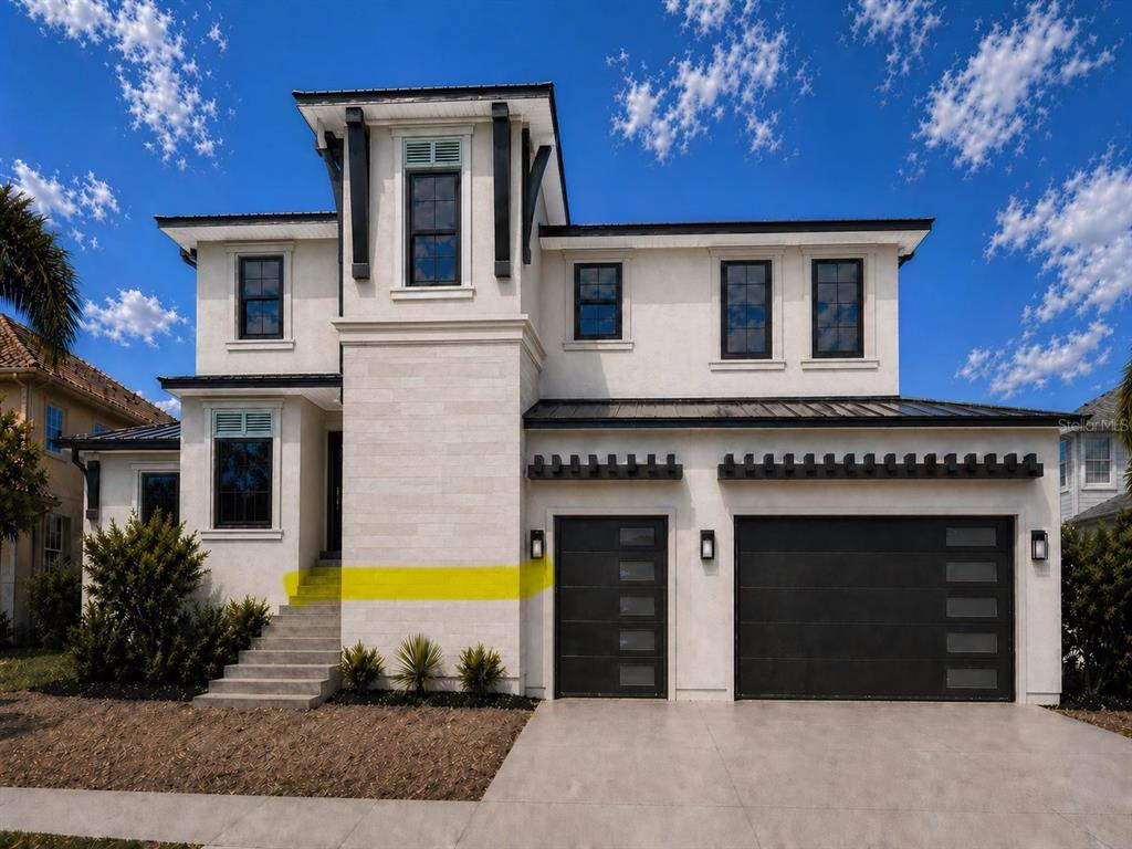 A two-story modern house with a white stucco facade, dark trim, and a three-car garage — 654 GENEVA PLACE, TAMPA, FL