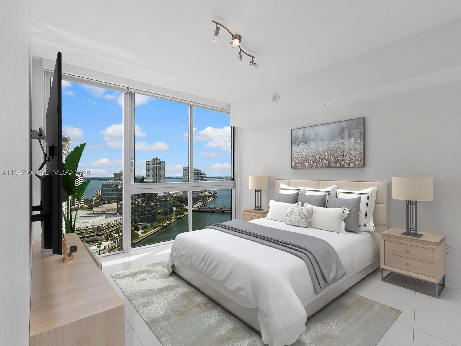 A bedroom with a bed, nightstands, and floor-to-ceiling windows overlooking a city and water view — 495 Brickell Ave # 1801, Miami FL 33131, MIAMI, FL