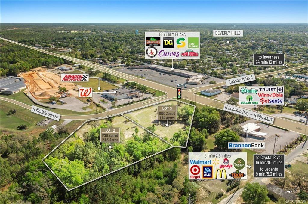 This aerial map shows two undeveloped lots for sale near a commercial shopping plaza — 4038 N MODELWOOD DRIVE, BEVERLY HILLS, FL
