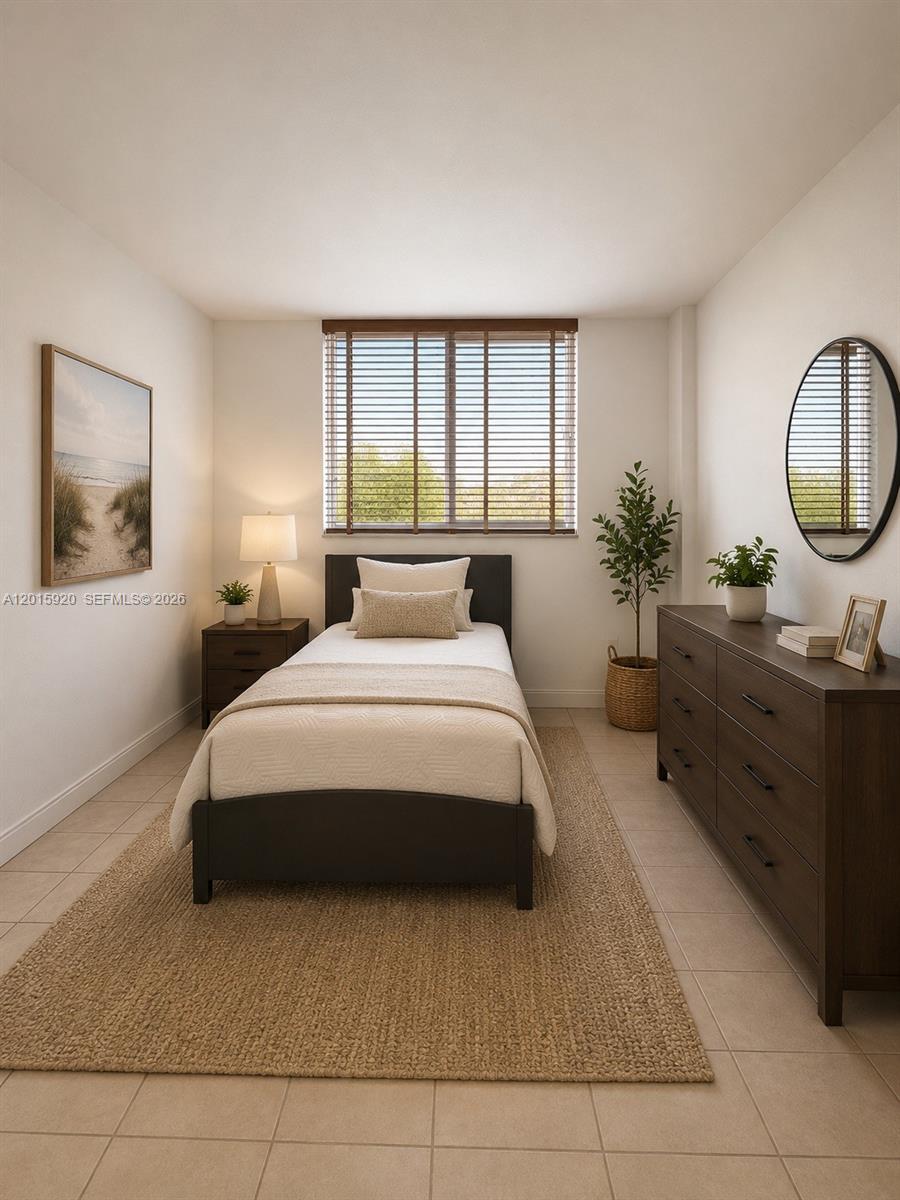 This bedroom features a single bed, a dark wood dresser, and a window with blinds — 14170 SW 84th St # F, Miami FL 33183, MIAMI, FL