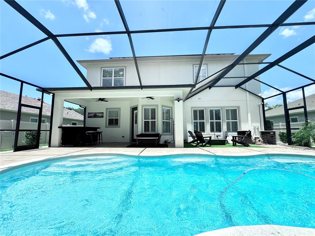 A two-story house with a screened-in pool and covered patio area — 212 MONTARA DRIVE, SEFFNER, FL